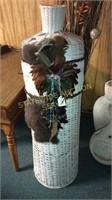 Wicker vase with fur and feather accents