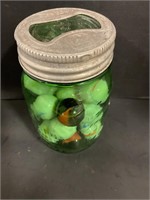 Green mason jar of marbles