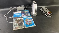 Powered on Nintendo Wii console with four games