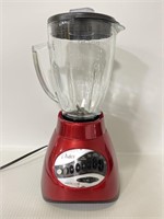 Red Oster brand precise blender - powers on