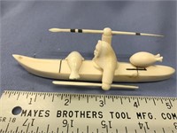 6" ivory carving of hunter in a kayak, with spear