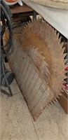 2 large saw blades and iron floor grate