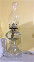 Antique clear glass oil lamp looks complete and