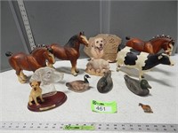 Toy horse  and farm animals; duck statues and a do
