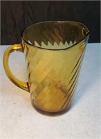 Amber colored glass pitcher approx 8 inches tall