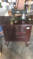 White sewing machine in cabinet