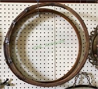 Two wooden barrel hoops with metal connections.