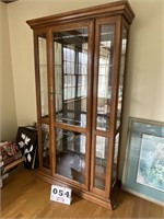 Curio cabinet with lead  glass and wood doors.
