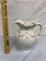 White pitcher with gold trim