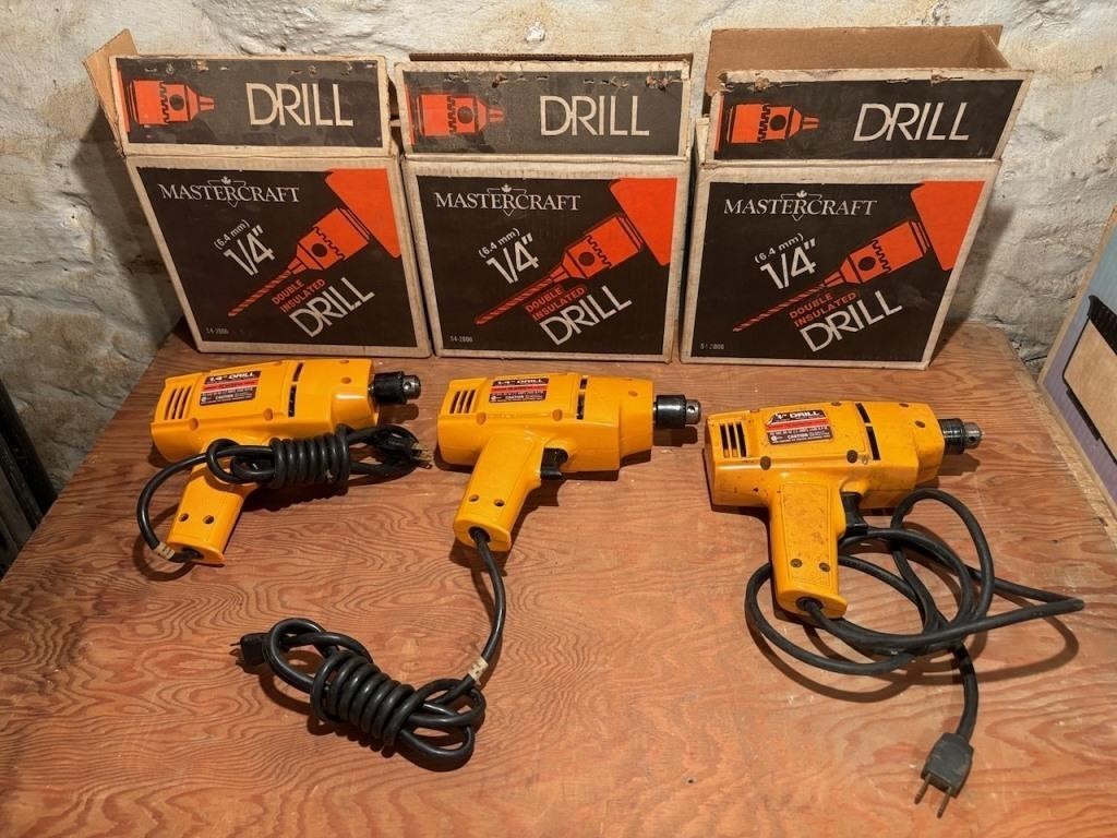 Three MasterCraft 1/4in Corded Drills in Boxes