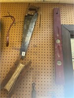 Handsaw, levels, hay hook and twine holder