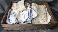Wood crate with hand done linens and doilies