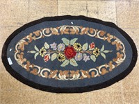 Antique floral hooked rug.
