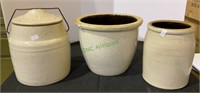 Three antique crocks - one with a lid. Some age