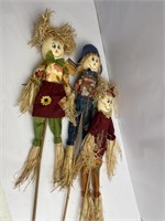 Lots of three scarecrows
