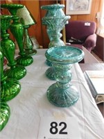 4 illuminated turquoise colored candlesticks in