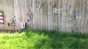 Red, white and blue decor on fence, you remove
