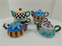 Tea Kettles 6.5" T, 7" W. Four colorful tea pots,
