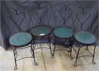 Four cast metal ice cream chairs with wooden seats
