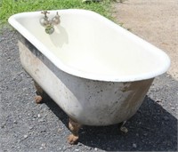 Original cast iron claw foot bath tub, appears as