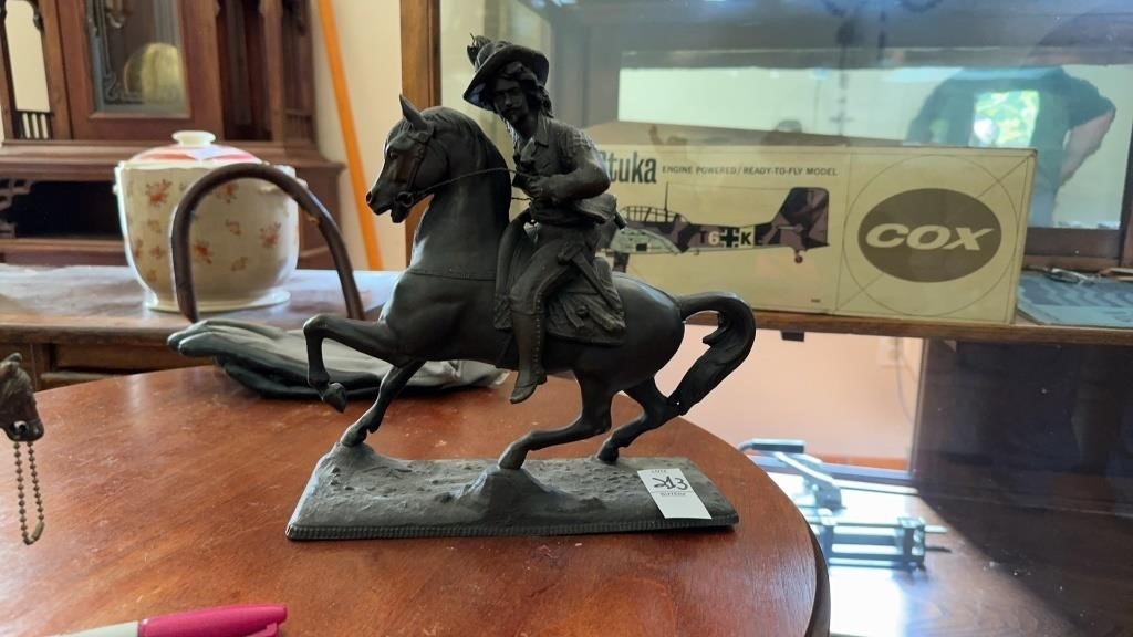 Cast iron cowboy and horse statue
