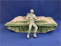 Plastic tank with USMC toy, both have wear