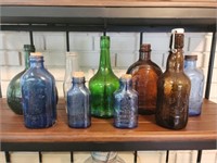 Shelf lot of vintage glass bottles