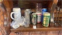 Shelf lot of beer cans and mugs