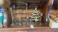 Shelf lot of brass candlestick holders