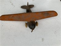 Old Metal plane with missing pieces on propeller