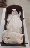 MEAN PORCELAIN BABY  DOLL IN WOODEN CRIB