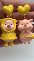 Fun pig earrings, 3D with yellow hearts above,