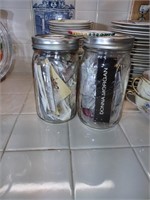 2 mason jars with buttons and more.