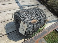 Unused roll of barbed wire.