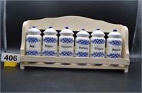 Vintage ceramic spice jars in wood rack