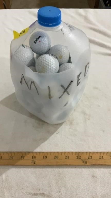 Milk jug full of golf balls