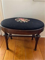 Antique oval footstool with a needlepoint top of