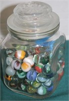 GLASS LIDDED JAR WITH MARBLES