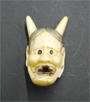 Antique Japanese carved ivory horned face netsuke