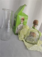 7" GLASS VASE AND A 6" PATRON BOTTLE- EMPTY BUT