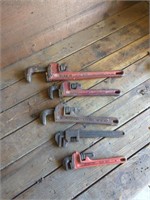 5 various sized pipe wrenches