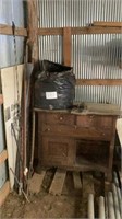 Cabinet, fence posts, trash bag of insulation