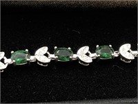 Tennis bracelet with emerald green cut stones a