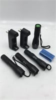 Four Small Black Flashlights with Two Plug In
