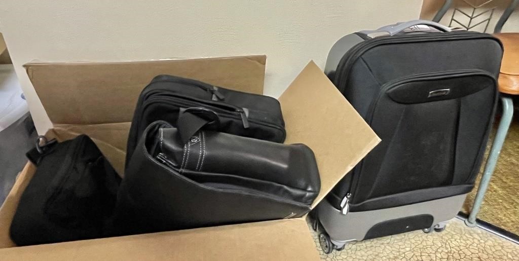 Box of laptop totes, rolling carry-on suitcase