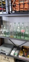 8 assorted Coca-Cola glass bottles