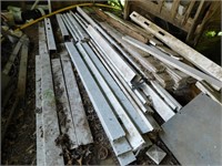 VINYL FENCE PARTS AND STACK OF WOOD