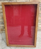 Display case with red fabric interior. About