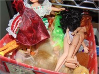 Box full of barbie dolls and small toys