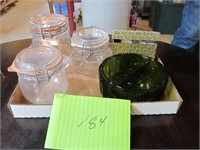 Three clear storage canisters,